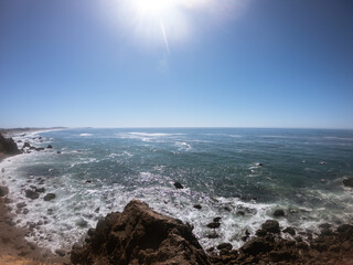 West California coast line, hills with grass and rocky reefs in Pacific ocean in Usa, America