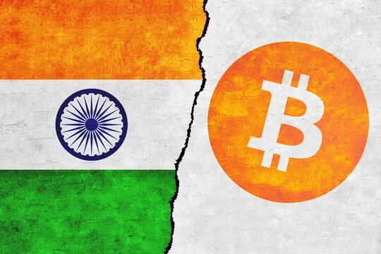 India and Bitcoin painted flags on a wall with a crack. Cryptocurrency with India flag images. Bitcoin and India flags together