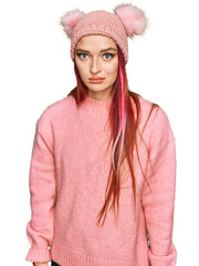 Young caucasian woman wearing casual clothes and wool cap skeptic and nervous, frowning upset...