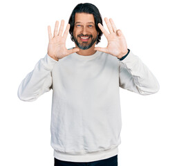 Middle age caucasian man wearing casual clothes showing and pointing up with fingers number nine...