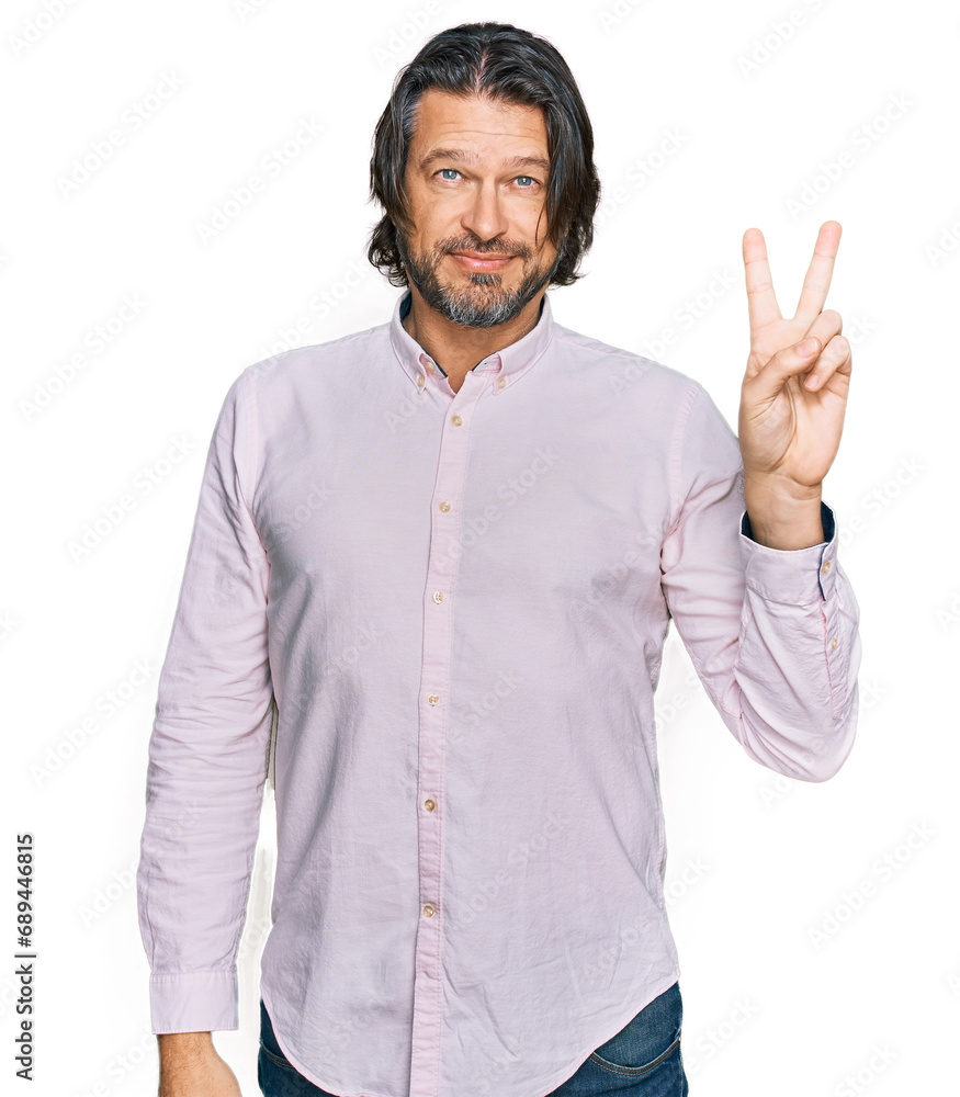 Wall mural Middle age handsome man wearing business shirt showing and pointing up with fingers number two while smiling confident and happy.