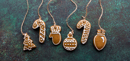 Gingerbread cookie ornaments with twine attached for hanging.