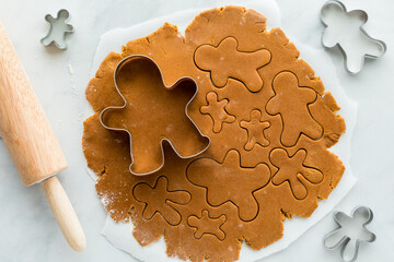 Gingerbread cookie dough rolled out and cut into gingerbread men.