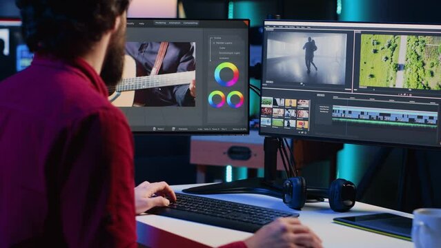 Professional video editor analyzing film montage before editing color grading and lighting in creative office. Post production studio employee working with raw footage, improving quality