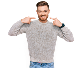 Young redhead man wearing casual winter sweater smiling cheerful showing and pointing with fingers teeth and mouth. dental health concept.