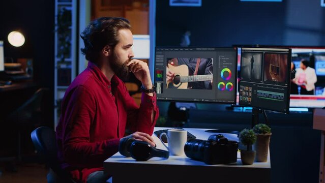 Videographer using editing software to assemble footage into cohesive final result, color correcting it to ensure project meets desired aesthetic, working in creative studio