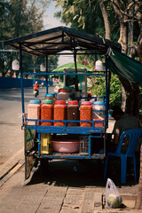 Food cart selling fruits and chili dip called Ombel bok on the side of the street, authentic khmer...