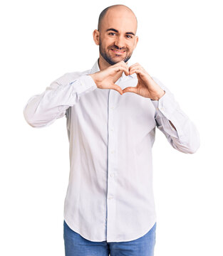 Young handsome man wearing elegant shirt smiling in love showing heart symbol and shape with hands. romantic concept.