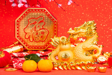 Tradition Chinese golden dragon statue,word on dragon Translation: good bless for year of the dragon,leafside word on paper and coin mean:good luck