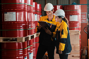Two factory workers or inventory inspector conduct professional inspection on hazardous chemical...