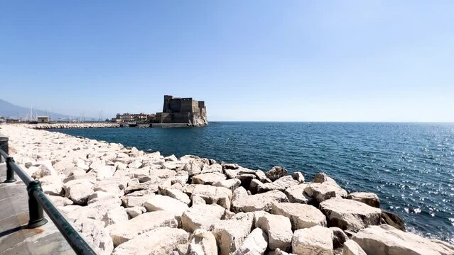 Seascape with ancient fortress on the coast under a clear sky - Castel dell'Ovo w Neapolu