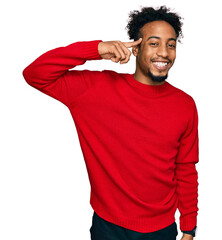 Young african american man with beard wearing casual winter sweater smiling pointing to head with...