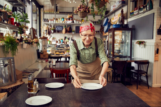Dedicated Server Setting the Table in a Welcoming Cafe
