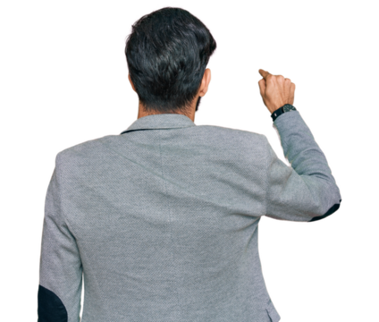 Young hispanic man wearing business clothes posing backwards pointing ahead with finger hand