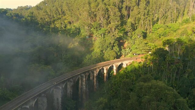 Establishing Aerial Drone Shot of 9 Arches Bridge on Sunny and Misty Morning in Ella Sri Lanka