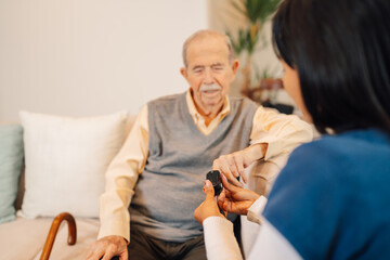 Nurse checking blood oxygen pressure to old man at home