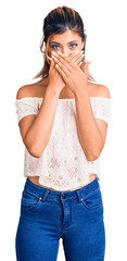 Young beautiful woman wearing casual clothes shocked covering mouth with hands for mistake. secret concept.