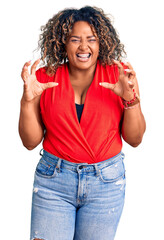 Young african american plus size woman wearing casual style with sleeveless shirt smiling funny...