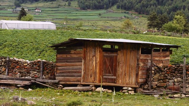Scenic view of a rustic cabin in the meadows in Phobjikha valley in Bhutan, scenic nature in Asia.