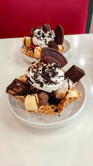 Gourmet summer dessert of artisanal or craft ice cream made with fresh, pistachio nuts and chocolate served in bowls