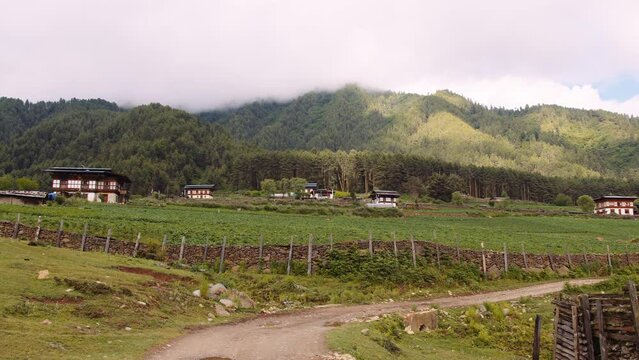 View of scenic landscape with mountains and clouds in Bhutan, view of the meadows in Phobjikha valley in Bhutan.