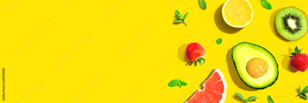 Poster avocado and mixed fruits overhead view flat lay