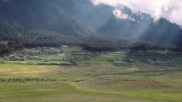 View of scenic landscape with mountains and clouds in Bhutan, view of the meadows in Phobjikha valley in Bhutan.
