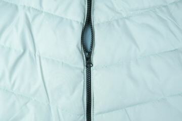 Texture of puffer, down jacket. Background of an urban winter outfit.