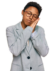 Young african american woman wearing business clothes sleeping tired dreaming and posing with hands together while smiling with closed eyes.