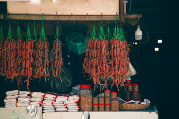Small shop displaying traditional pork and beef sausages called twa koh, kwah koh or sach krok, authentic khmer cuisine and culture of Cambodia - obrazy, fototapety, plakaty