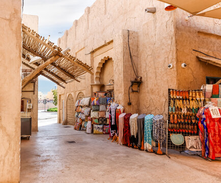 Shop with souvenirs and national dresses, scarves and fabrics in the reconstructed old part of the Dubai city - Al-Bastakiya quarter in the Dubai city, United Arab Emirates