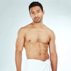 Chest, body and portrait of asian man in a towel in studio for cleaning, hygiene and care on grey...