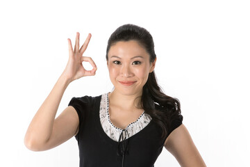 Asian woman doing OK symbol with her hand.