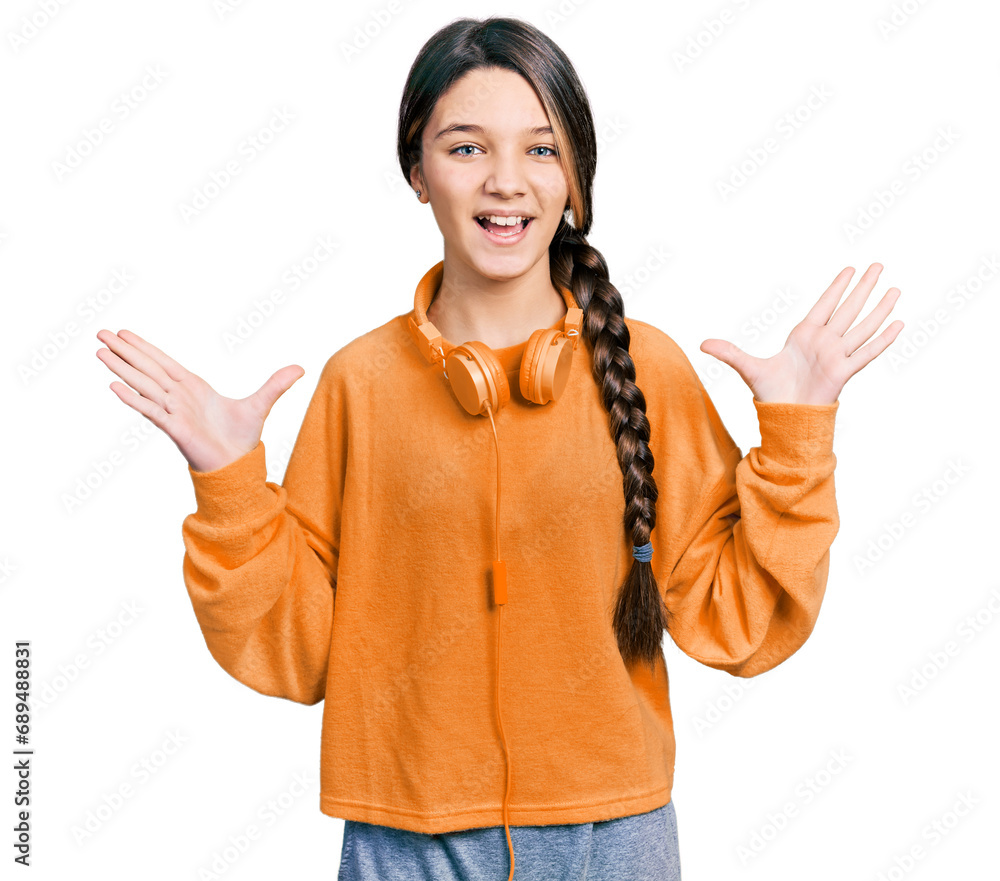 Sticker young brunette girl with long hair wearing sweatshirt and headphones celebrating crazy and amazed fo