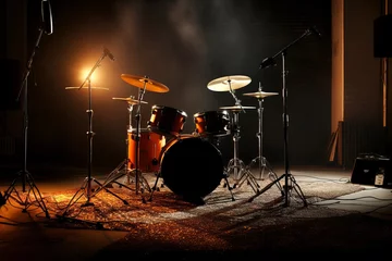 Fotobehang drum kit on a dark music stage in warm cozy lighting © Александр Довянский