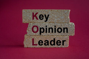 Key Opinion Leader symbol. Concept words KOL key opinion leader on brick blocks. Beautiful red...