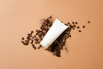 An unlabeled cosmetic tube is placed on top of coffee beans and coffee powder on a brown...