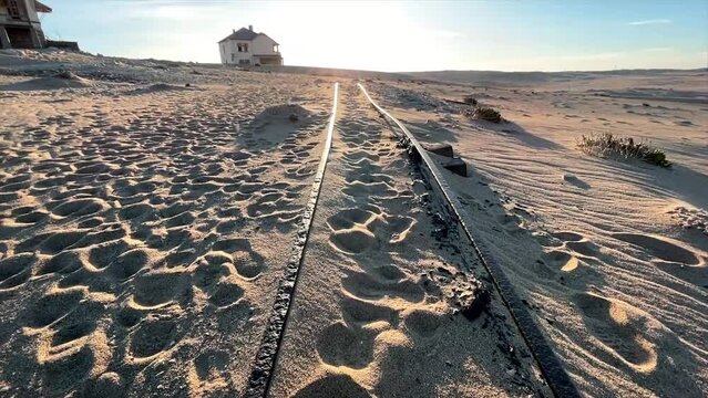 Train tracks covered in sand in the ghost town of Kolmannskuppe Namibia
