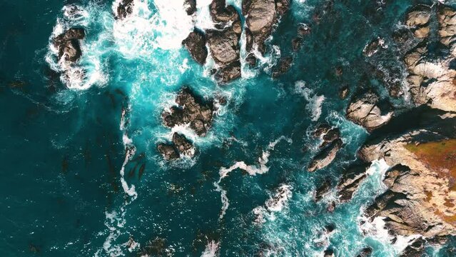 Cliff rock seaside coast in slow motion in California. Famous Highway One Big Sur. Aerial.