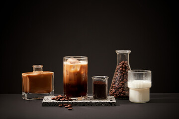The ingredients for making milk coffee are displayed on a black background. Long-term drinking of caffeinated coffee has been associated with a reduced risk of prediabetes and diabetes.