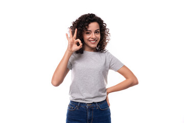 pretty young curly brunette woman in casual t-shirt on white background with copy space