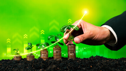 Growing coin or money stack with ESG businessman hand interacting symbolize eco investment with...