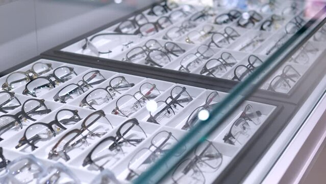 Optical store offers range of glasses for vision correction. Window of optical store displays lenses and frames of various shapes Optical consultants will choose lenses desired diopter and ideal frame