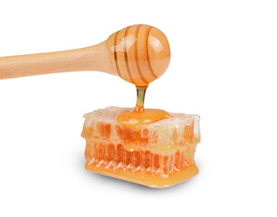 Sweet honeycomb and wooden dipper with dripping honey isolated on transparent