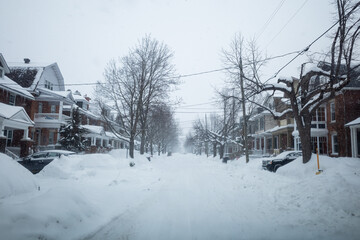 Driving down a road during a winter storm in Ottawa, Ontario. Road is covered by snow, cars, passing 