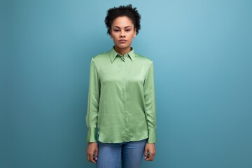 charming young brunette hispanic woman dressed in a green blouse on the background with copy space. people lifestyle concept