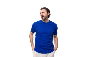 young european brunette man with beard yawns on white background