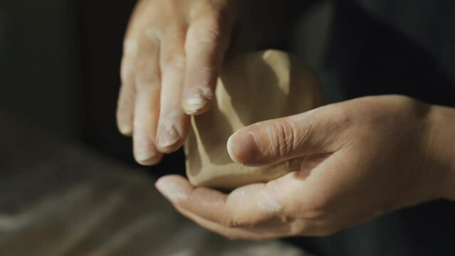 A woman makes a clay product with her hands - a ceramic pot. Close-up. Creative hobby.