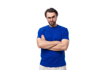 young brutal caucasian brunette man with stylish haircut and beard in blue t-shirt with identity...