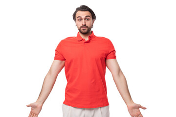 young pleasant friendly man with black hair and beard dressed in a red t-shirt on a white background with copy space
